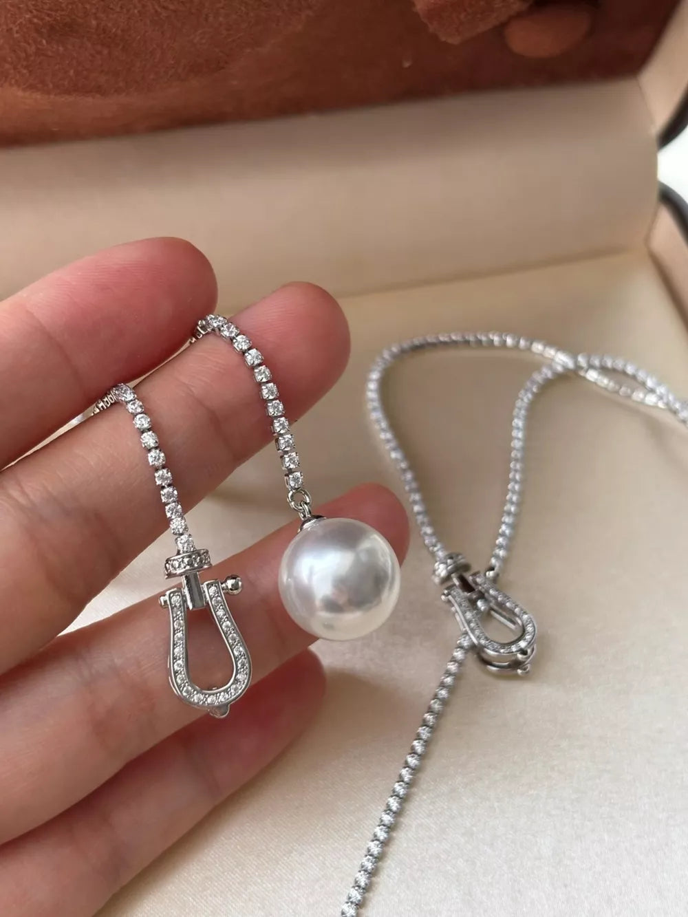 Lustrous pearl drop Y-necklace with diamond horseshoe clasp and chain