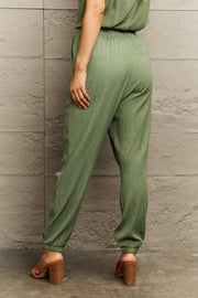 Matcha green textured gauze drawstring jogger trousers with elasticated cuffs.