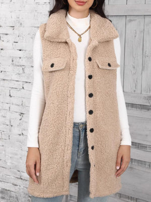 Tan sherpa utility vest with collar, button front, and chest pockets.