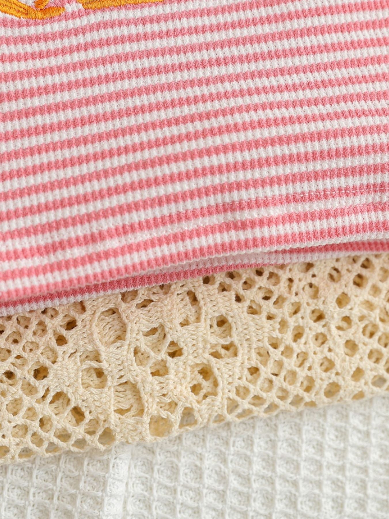 Baby set with pink and white stripes, crochet trim, and waffle knit fabric.