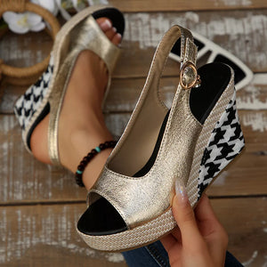 Gold open-toe wedge sandals with houndstooth pattern and decorative buckle detail.