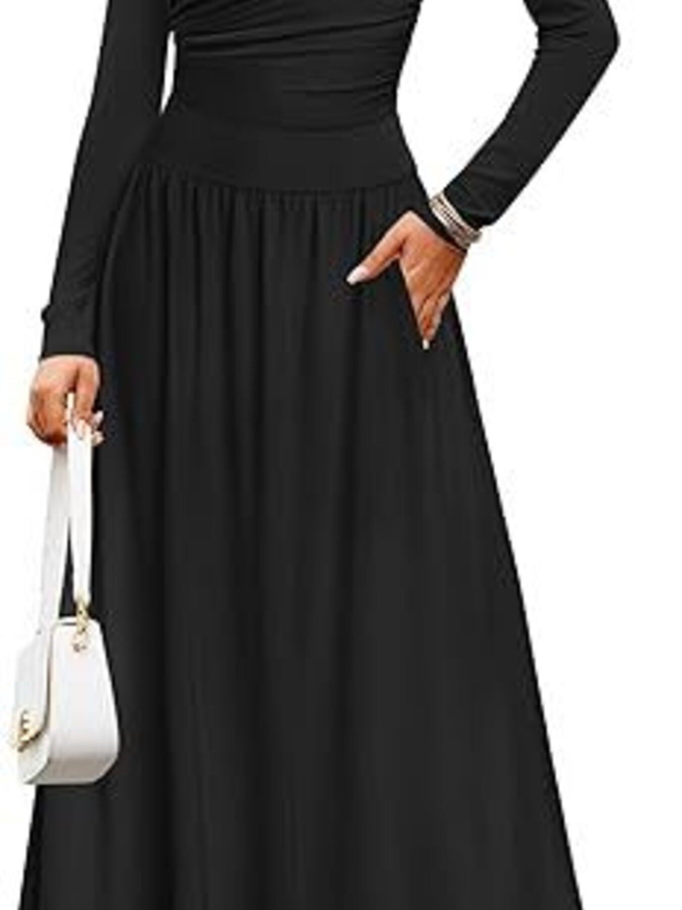 Black ruched long sleeve maxi dress with pockets and a white handbag.