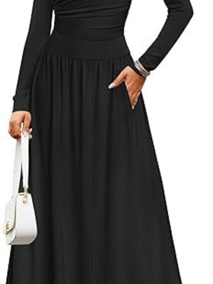Black ruched long sleeve maxi dress with pockets and a white handbag.