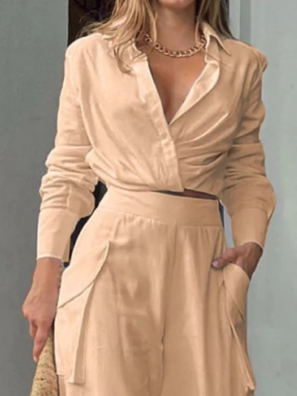 Chic tan two-piece set with ruched shirt and pocketed pants.