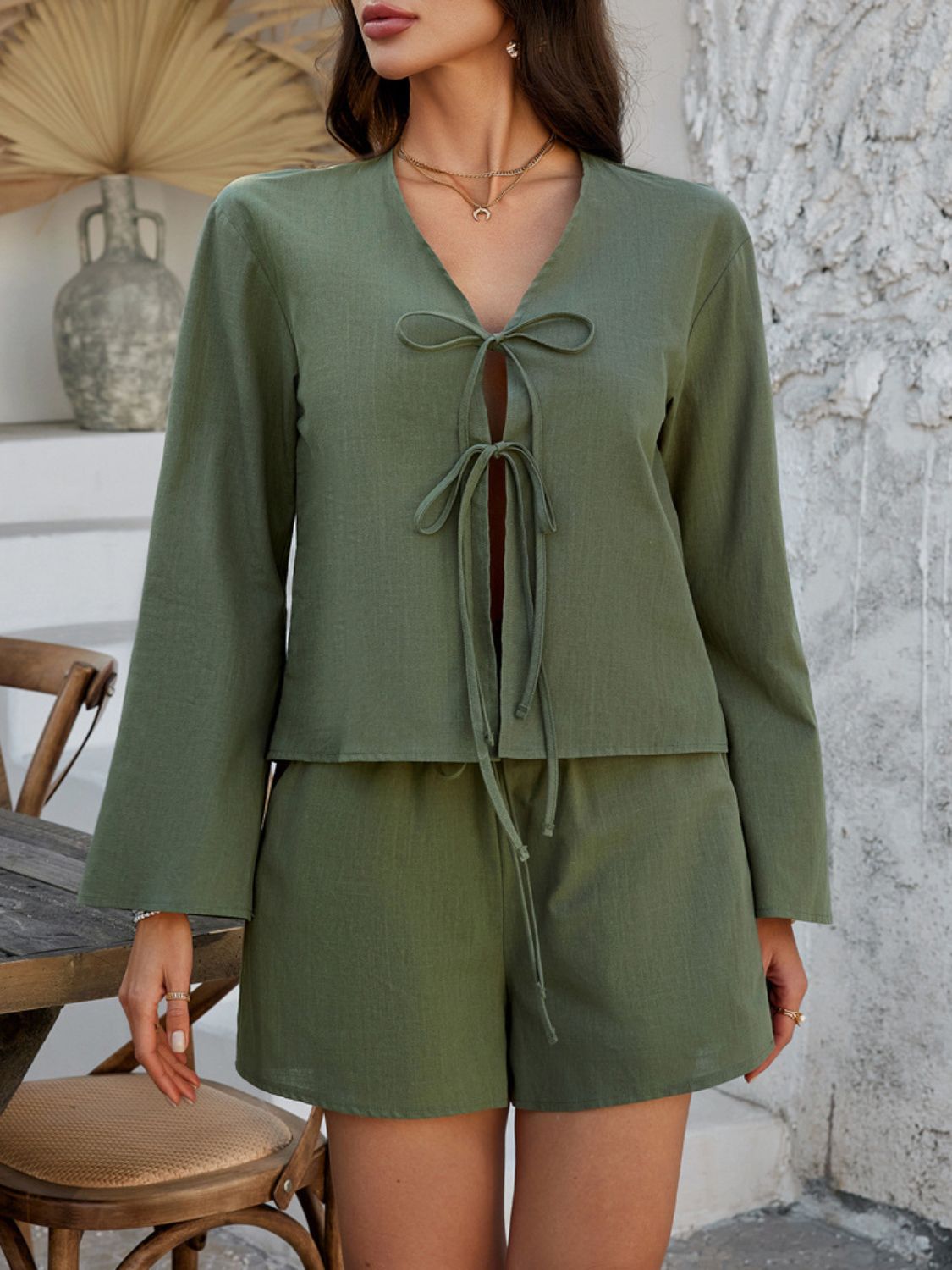 Matcha green linen tie-front top and shorts set with long bell sleeves.
