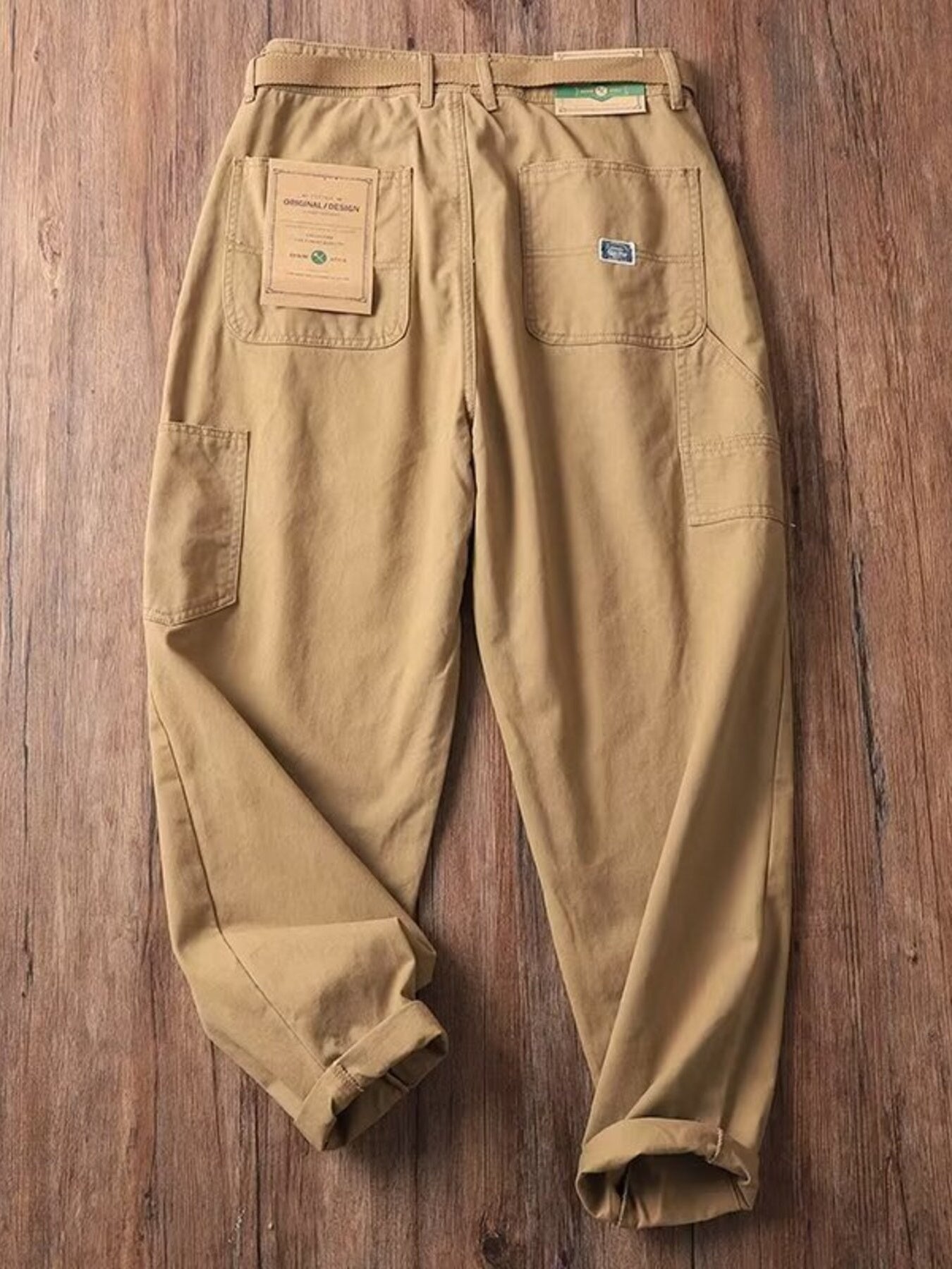 Men's tan loose fit cargo sweatpants with multiple pockets and a belt.