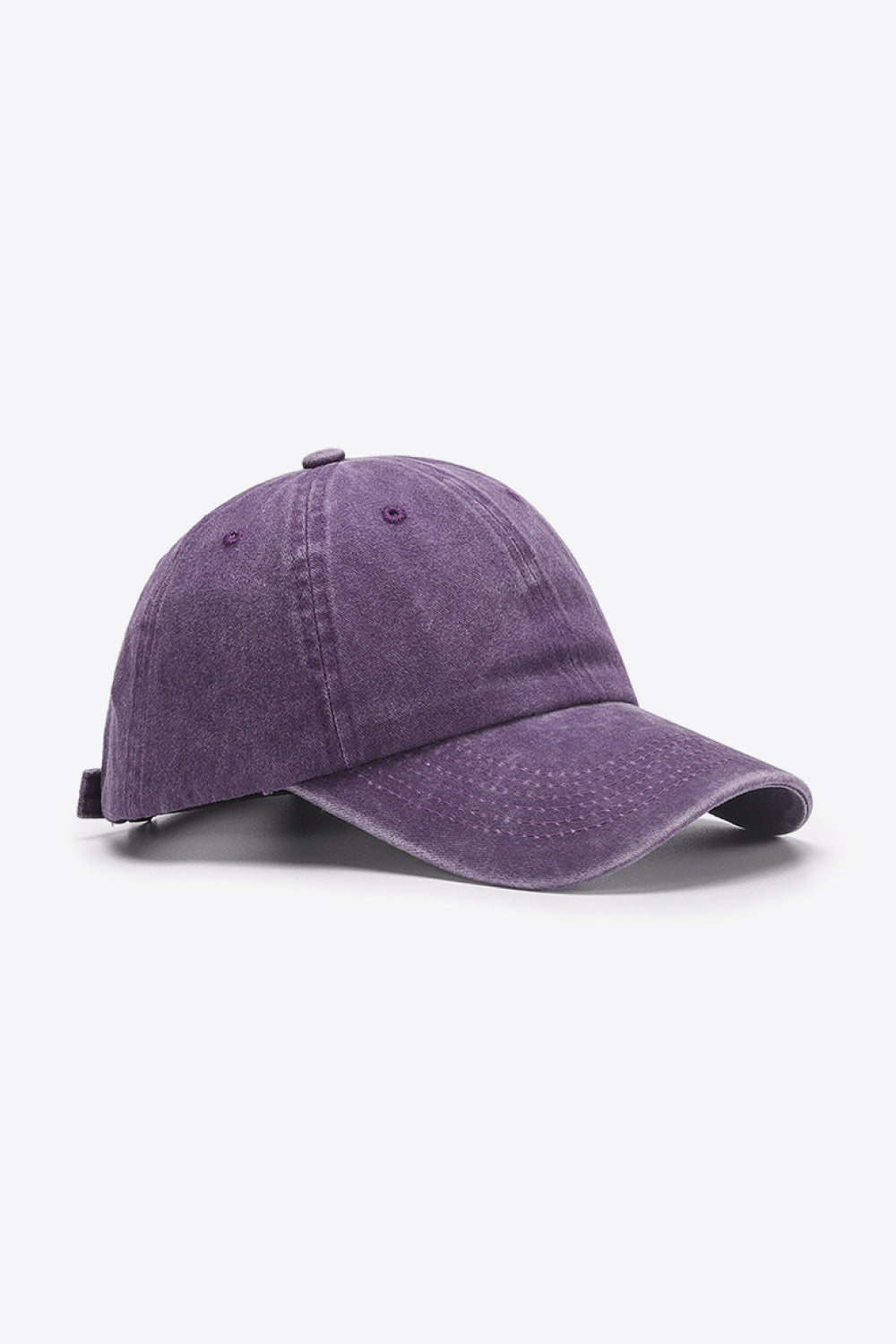 Washed cotton baseball cap in purple with adjustable strap and embroidered eyelets.