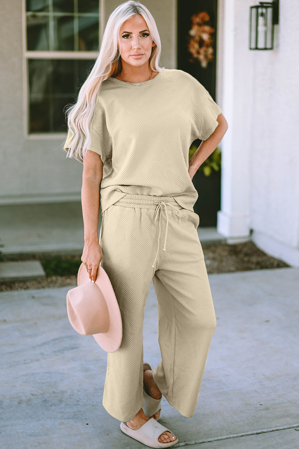 Beige textured knit tee and wide leg pants set with drawstring waist and geometric pattern.