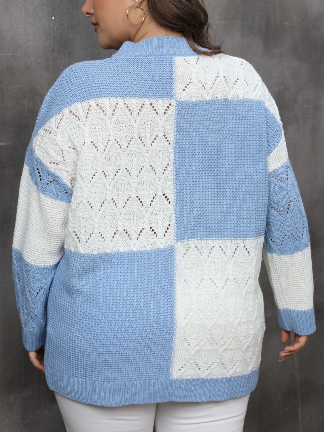 Light blue and white geometric openwork patchwork knit sweater with long sleeves.