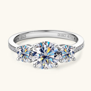 Silver band ring with three round moissanite stones and pavé accents.