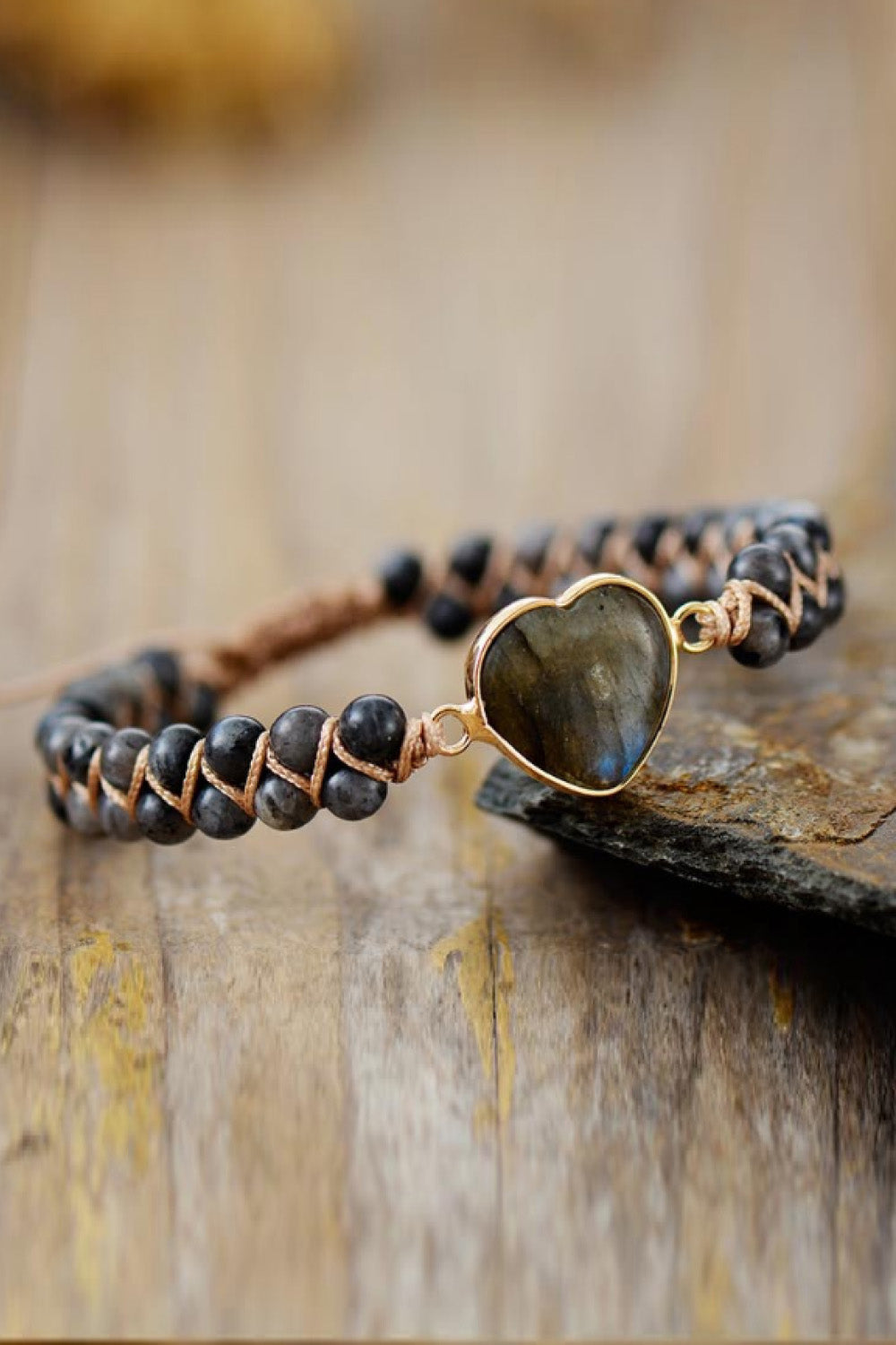 Beaded bracelet with a heart-shaped stone and gold-tone setting.