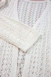 White open-knit crochet sleeve cardigan with intricate openwork pattern and ribbed cuffs.