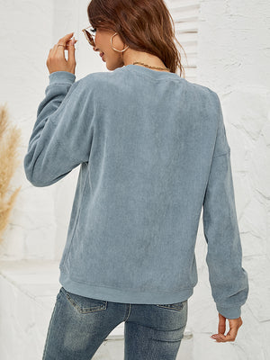 Corduroy crewneck sweatshirt in Deep Teal with a lip print, long sleeves, and relaxed fit.