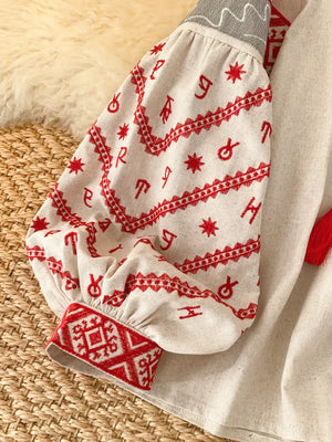 Embroidered folk shirt in cream with red embroidery on puff sleeves and cuffs.