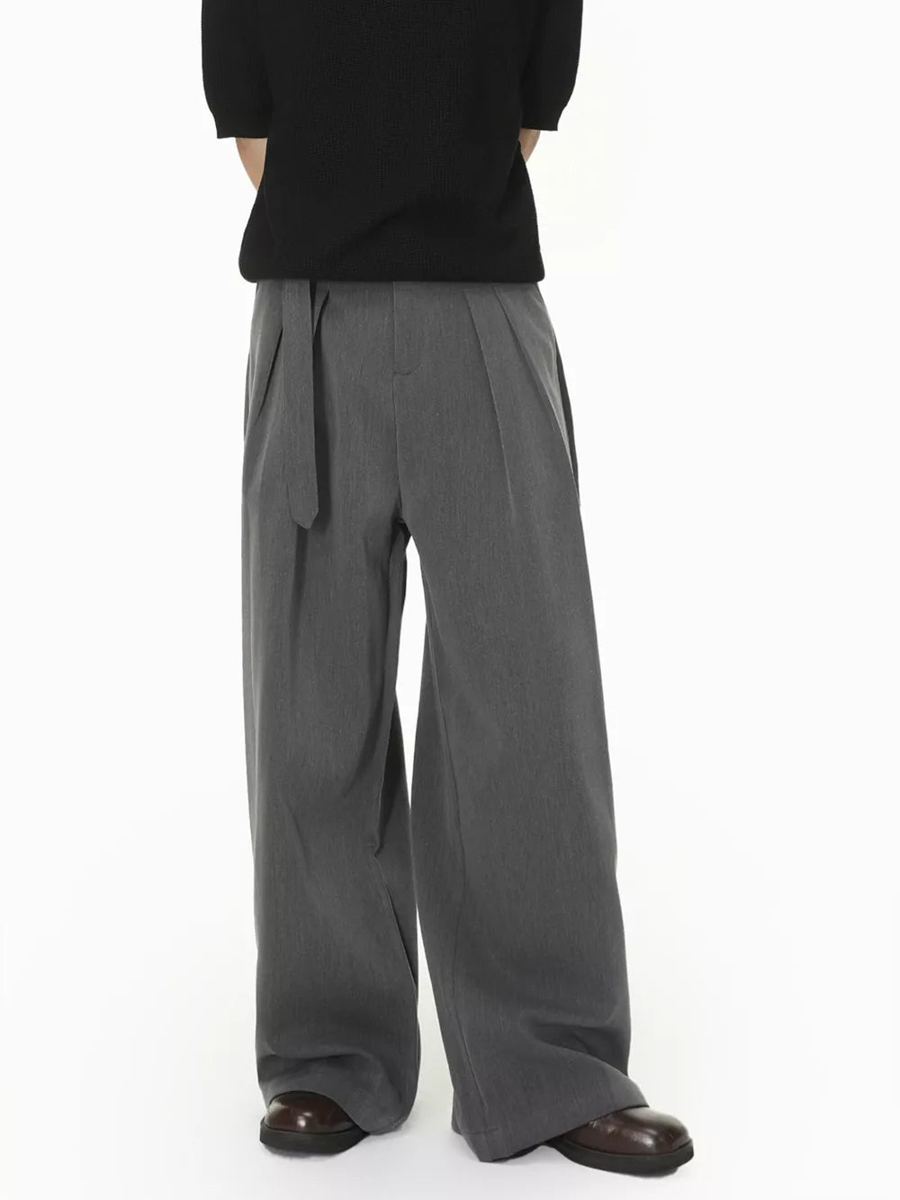 Grey wide-leg pleated sweatpants with a belted waist.