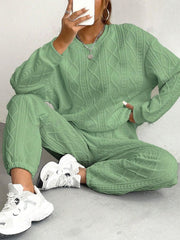 Cable knit lounge set in Gum Leaf green, featuring a crewneck sweater and jogger pants with textured pattern.