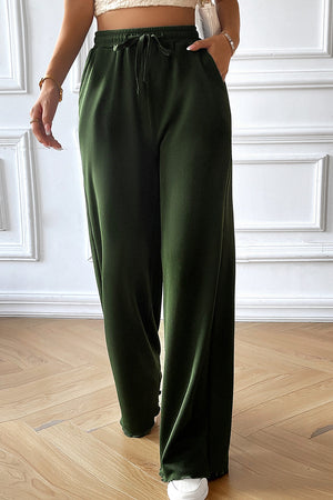 Textured rib wide-leg drawstring trousers in dark green, shown on a model.