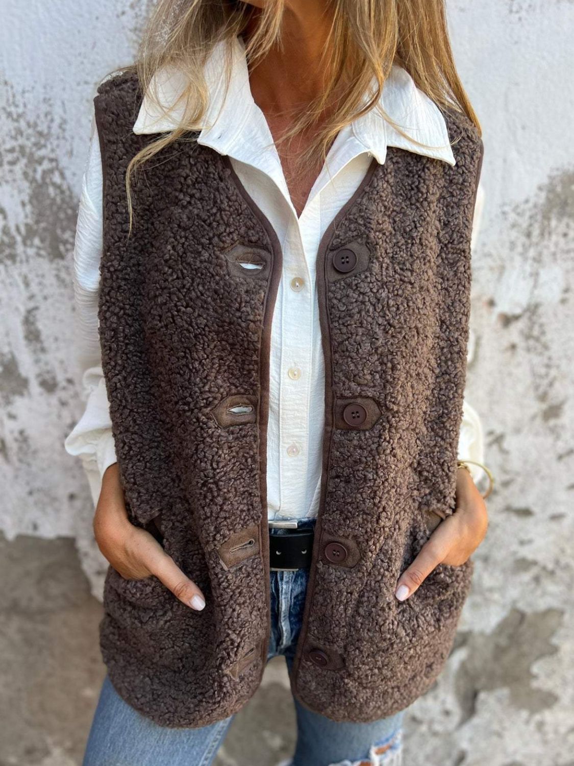 Brown teddy bear vest with leather trim and buttons, worn over a white shirt.