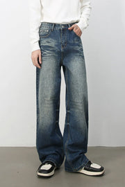 Oversized wide-leg jeans in medium wash denim with distressed details and a relaxed fit.