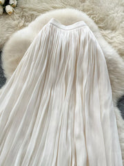 Cream pleated maxi skirt with a flowy, elegant cut.