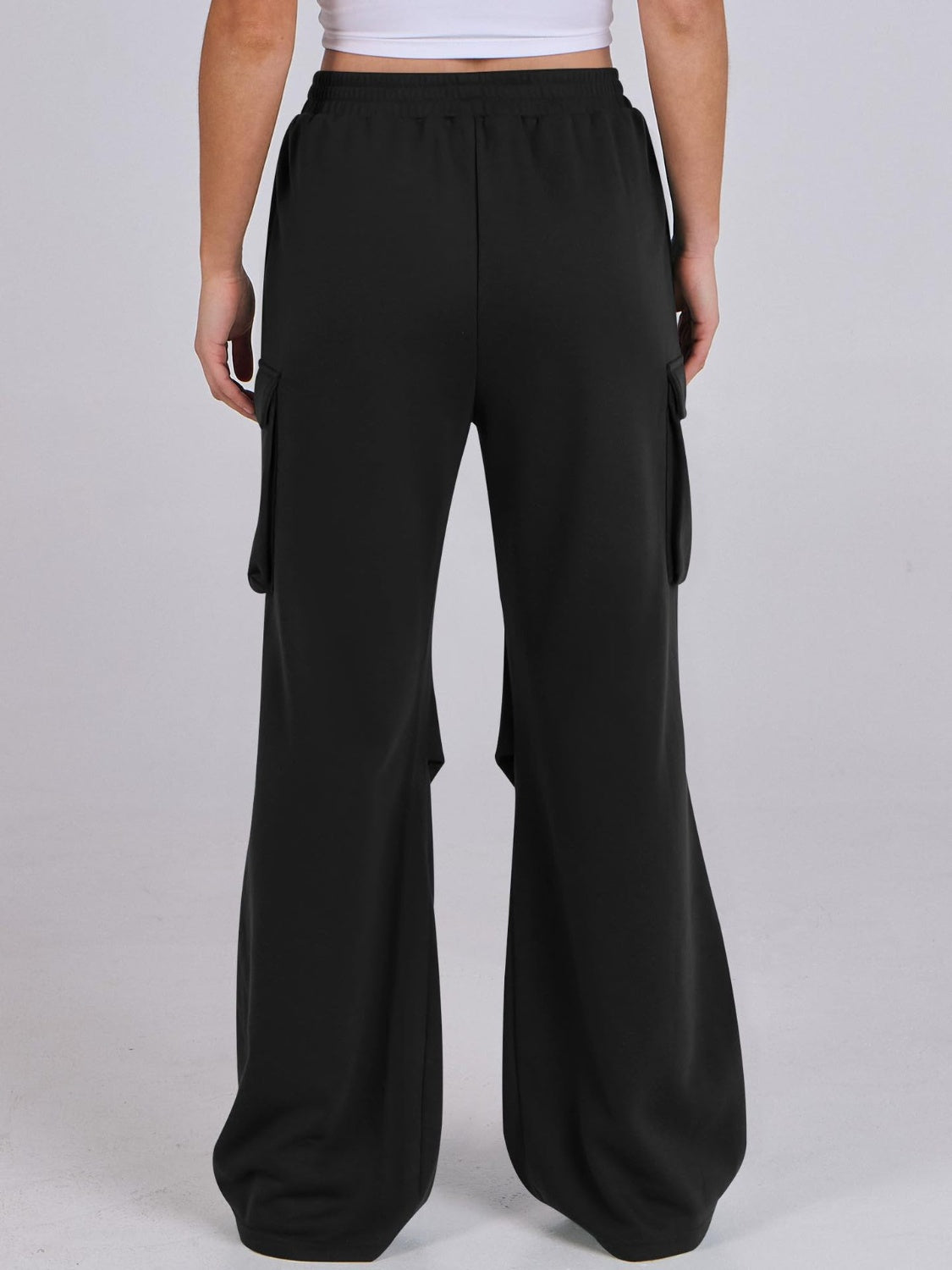 Black cargo pocket drape wide leg sweatpants with elastic waist.