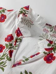 V-neck mini dress in white cotton with red floral print and ruffled collar detail.