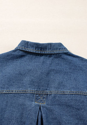 Denim trucker jacket in medium blue with collar and yoke detail.