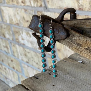 Turquoise stone cascade earrings with silver alloy settings.