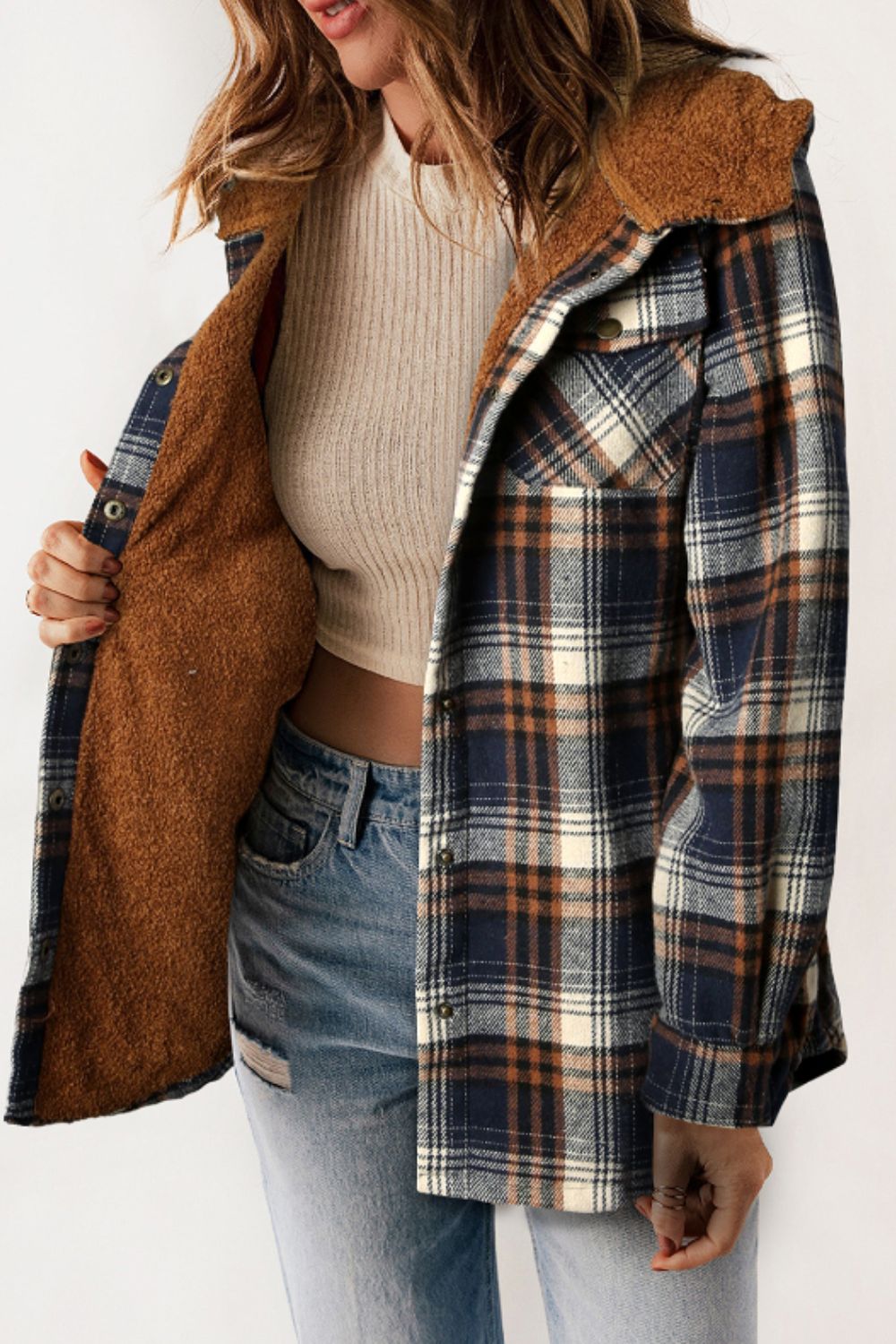 Sherpa-lined plaid overshirt jacket in navy, tan, and cream with button front and chest pockets.