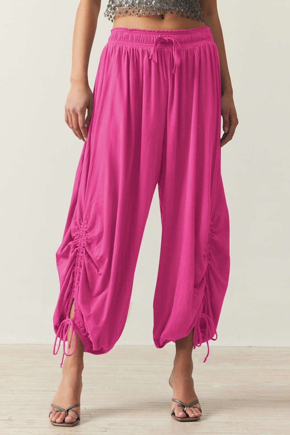 Hot Pink gathered ankle-tie balloon trousers with drawstring waist and ruched sides.