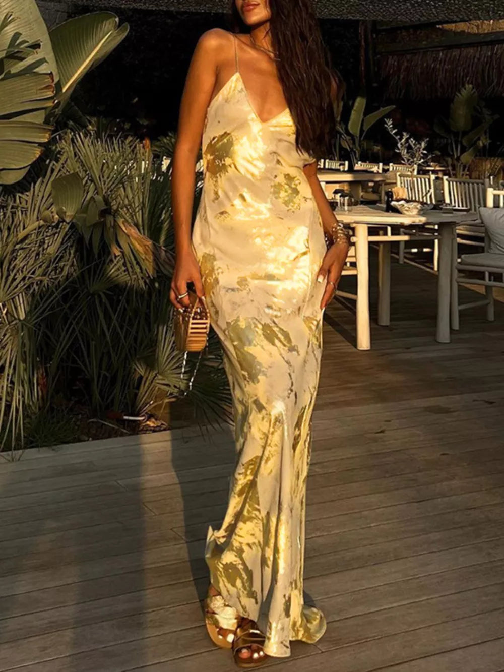 Elegant backless v-neck maxi gown in cream with abstract pattern.