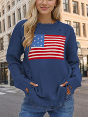 French blue knit sweater with distressed details and an American flag graphic.