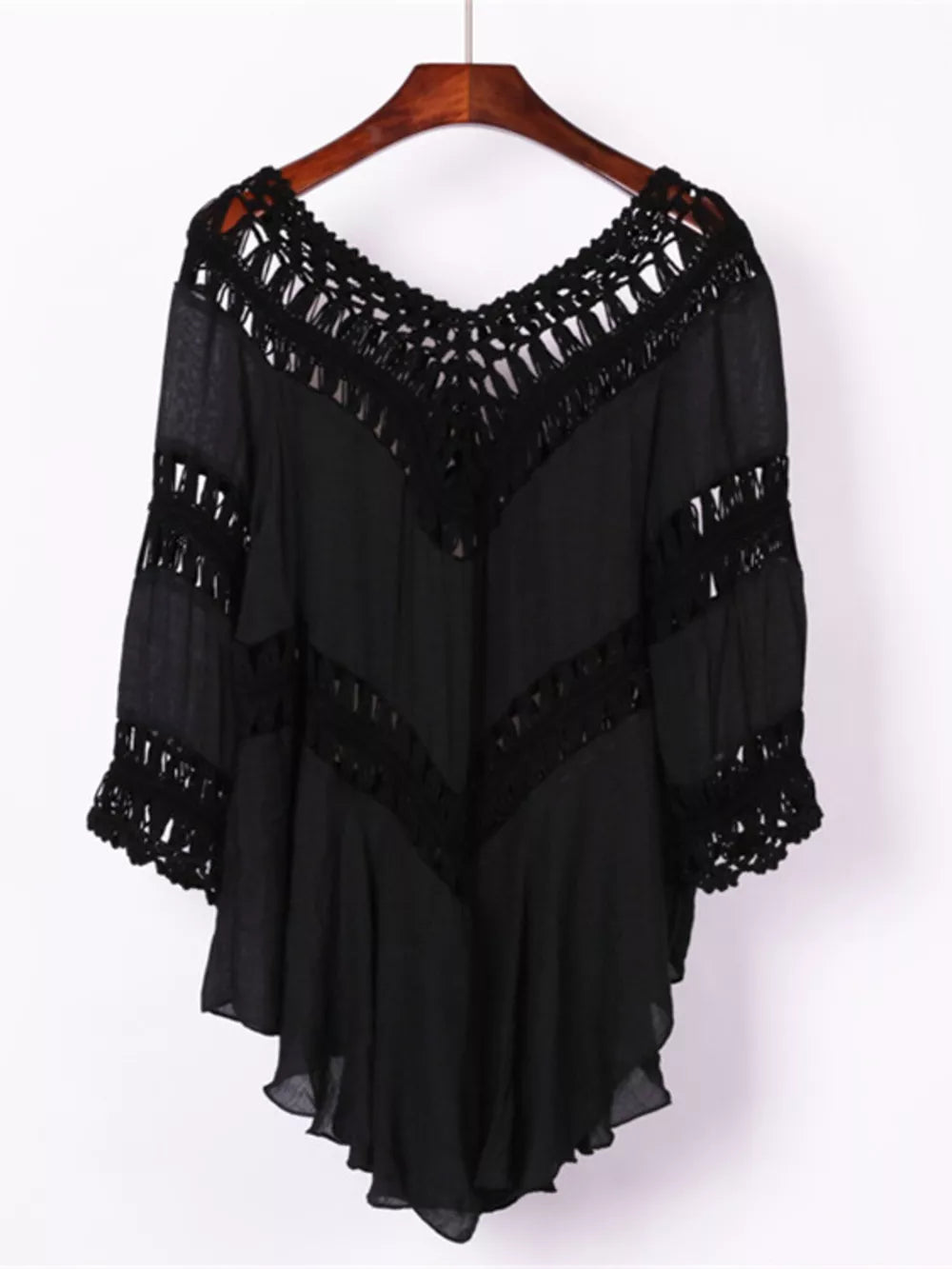 Black flowy cover-up with crochet trim and fringe details on V-neck and sleeves.