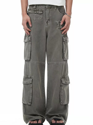 Men's grey distressed cargo pants with multiple utility pockets and a relaxed fit.