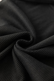 Black ribbed knit fabric detail, showing texture and drape