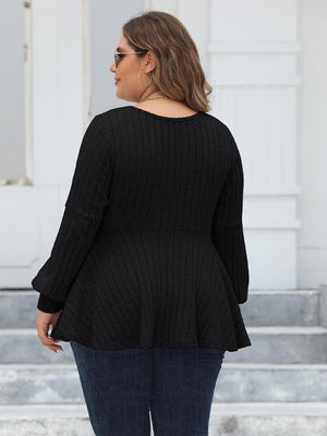 Black ribbed peplum blouse with blouson sleeves and a flared hem.