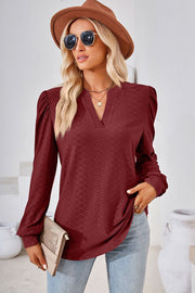 Textured puff sleeve henley blouse in Rust with a V-neck and diamond pattern.