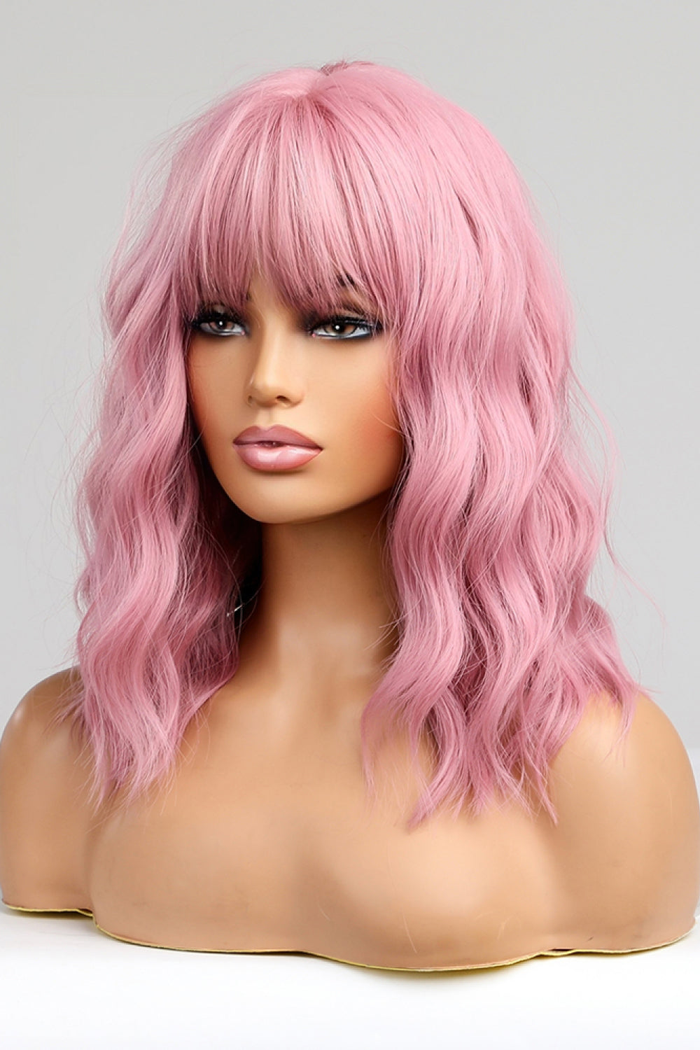 Pink bob wig with bangs and wavy texture