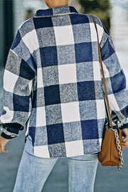 Oversized blue and white checkered shacket with button-down front and patch pocket detail.