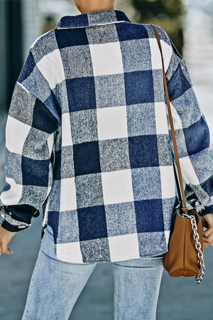 Oversized blue and white checkered shacket with button-down front and patch pocket detail.