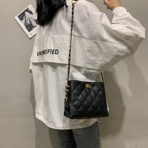 Black quilted crossbody bag with diamond pattern and gold chain strap.