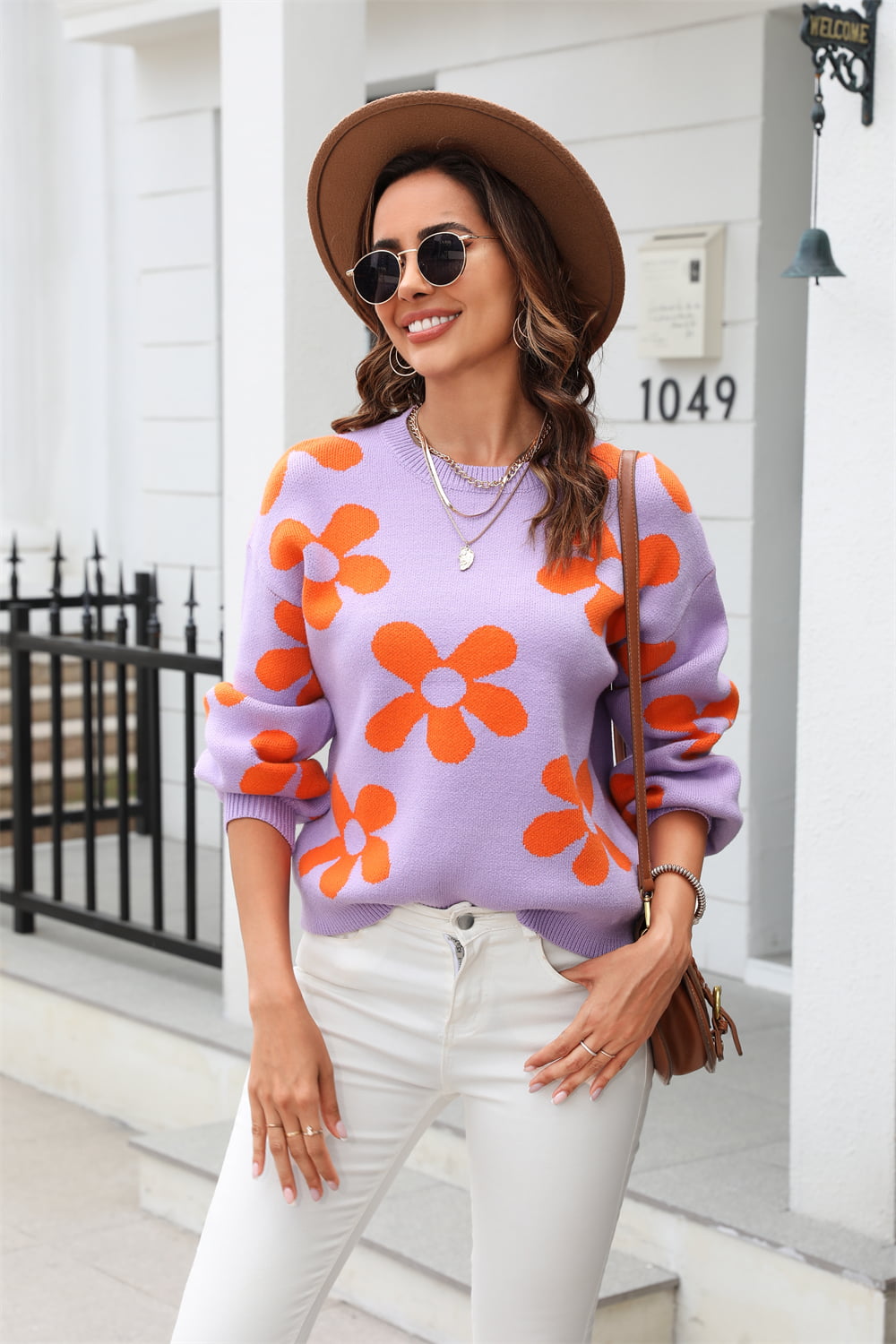 Lavender acrylic sweater with orange flower intarsia pattern, crew neck, long sleeves.