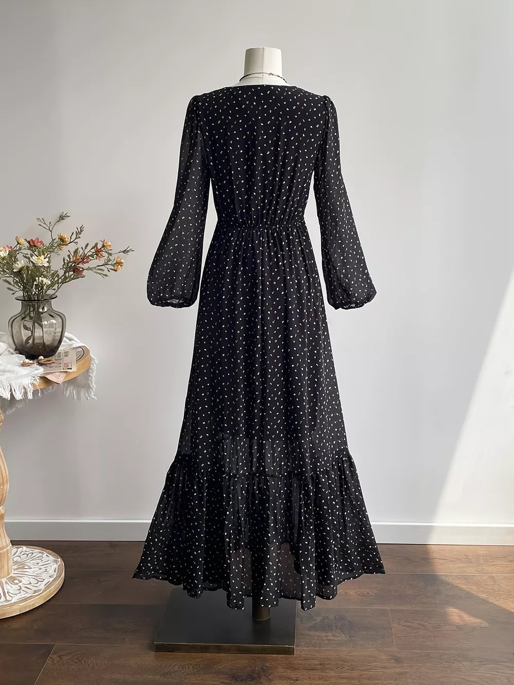 Black embroidered floral maxi dress with long sleeves and tiered hem.