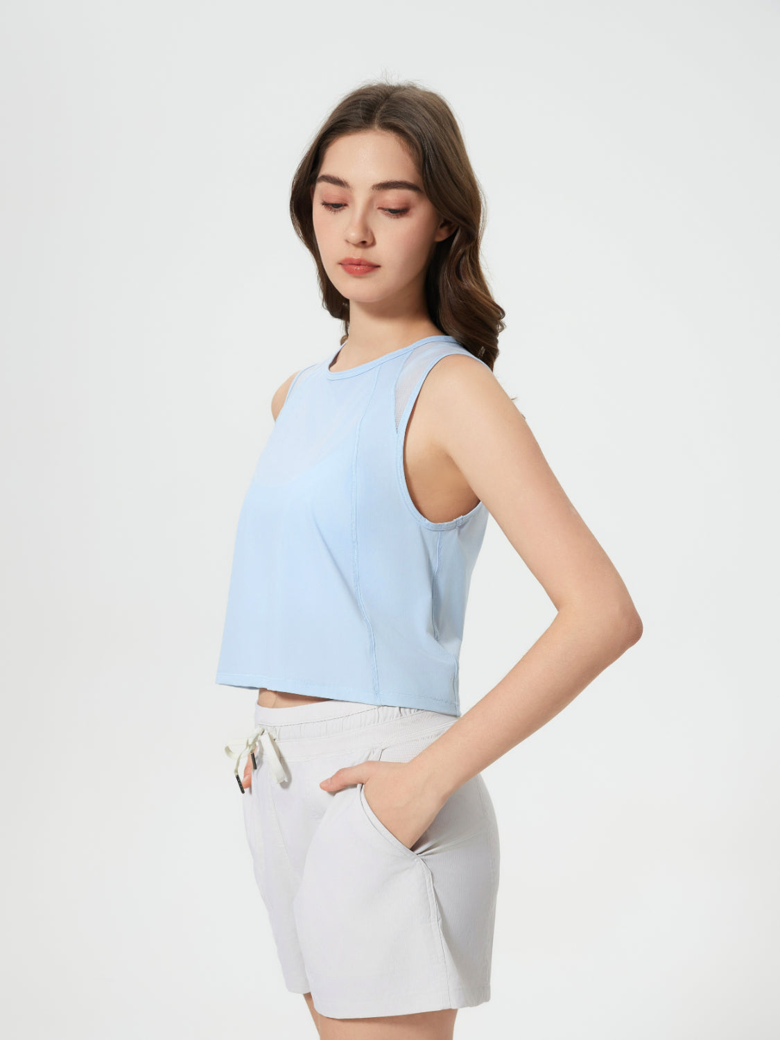 Baby Blue mesh-inset back cropped active tank top with round neckline and sleeveless design.