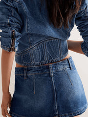 Classic denim mini skort in dark blue with button closure and belt loops.