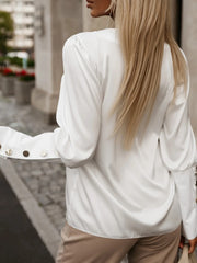 White blouson sleeve V-neck top with button cuffs
