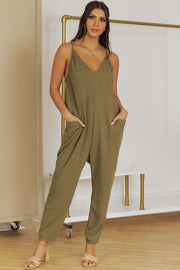 Relaxed-fit olive green jersey jumpsuit with V-neck, spaghetti straps, and slouch pockets.