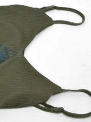 Botanical print spaghetti strap maxi dress in green with textured fabric and blue floral detail.