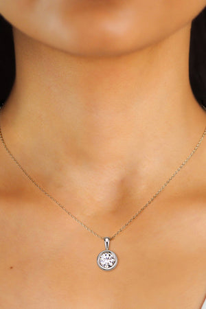 Silver solitaire bezel pendant necklace with a clear stone on a delicate chain.