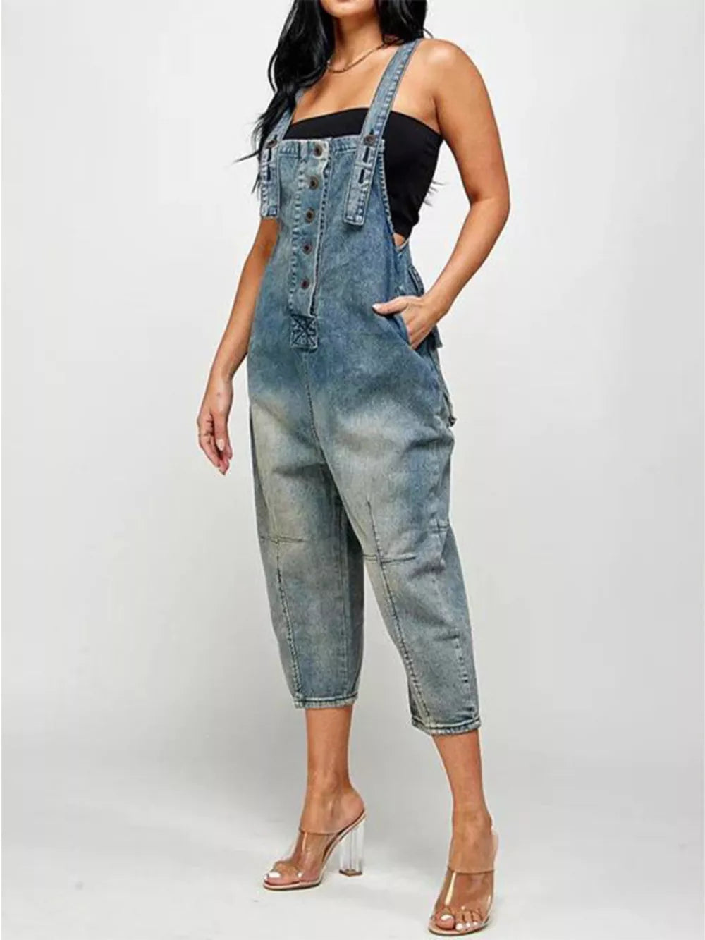 Light blue denim overalls with button-front, adjustable straps, and cropped leg